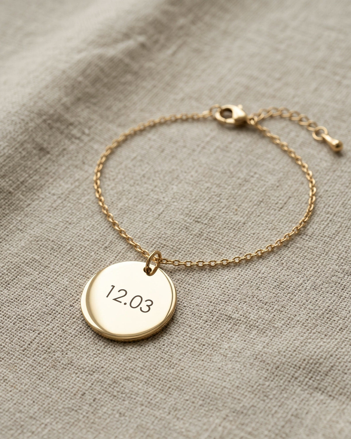 Nº 11, armband met munt 20 mm, goudkleurig roestvrij staal, op linnen ondergrond